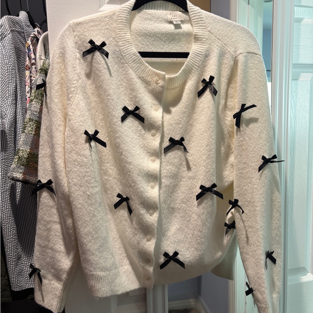 a new day Cream Cardigan with Black Bow Appliqués